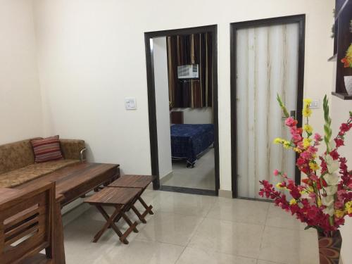 a living room with a couch and a table at The Raveesh E24 - 2BHK Serviced Apartment in New Delhi