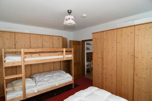バート・ミッテルンドルフにあるHappy Stay Apartmentの木製の壁の客室で、二段ベッド2組が備わります。