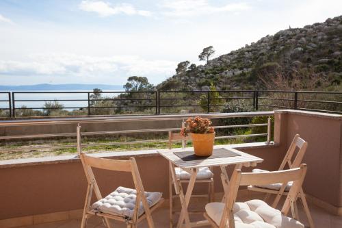 a table and two chairs on a balcony with a view at Relax Makarska in Makarska