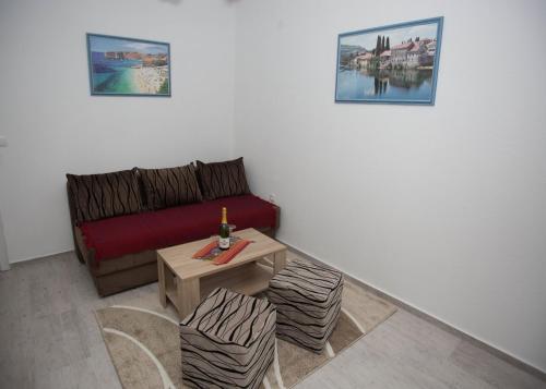 a living room with a couch and a table at Apartments Phoenix in Ivanica