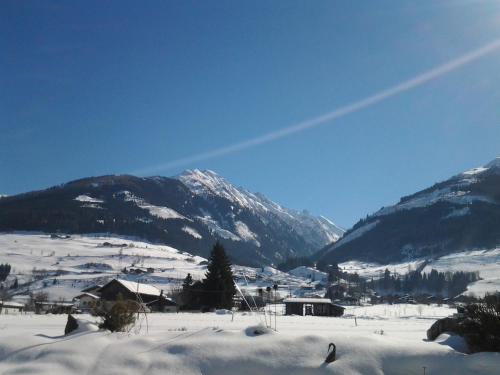 a snow covered valley with mountains in the background at Apartment Kaprun in Niedernsill