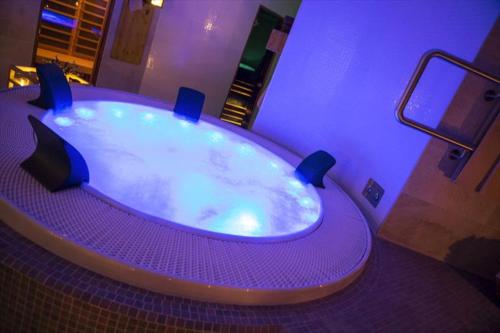 a large purple bath tub in a room at Drevenica Jánošík 2 in Terchová