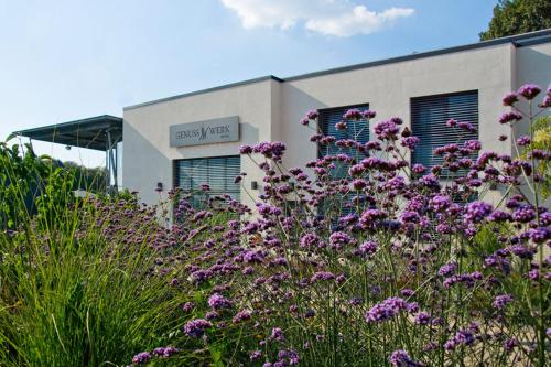 a field of purple flowers in front of a building at Boutiquehotel Genusswerk Eifel in Körperich