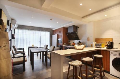 a kitchen and living room with a table and chairs at MIJU HOUSE Jingan-a quiet old house in downtown-flavor of life in Shanghai alley in Shanghai