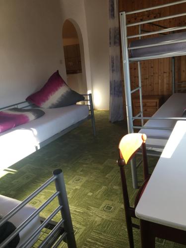 a room with two bunk beds and a table and a chair at Zur Krone in Wolfsegg