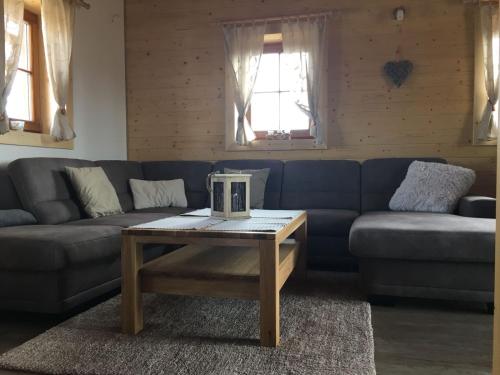 a living room with a blue couch and a coffee table at Chata Eden in Hrabušice
