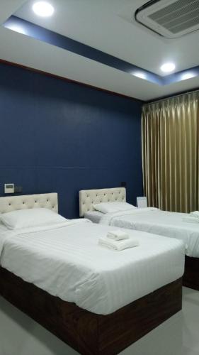 Tempat tidur dalam kamar di Landmark Maha Sarakham