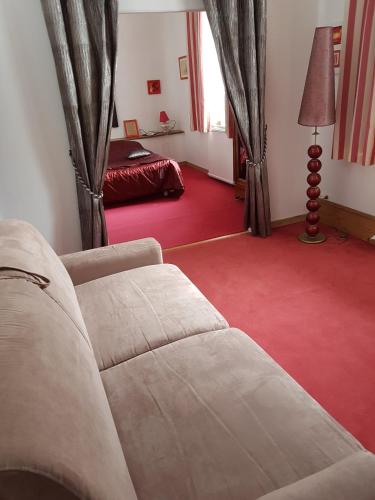 a living room with a couch and a bed at Le moulin de Varax in Saint-Paul-de-Varax
