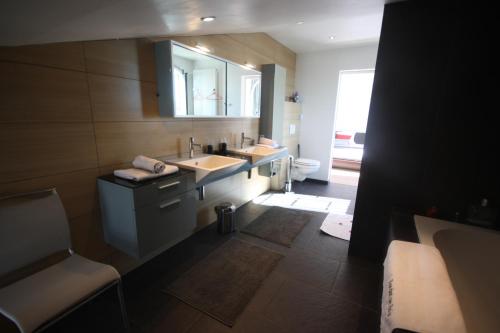 a bathroom with a sink and a mirror at Chambres d'Hôtes LA PASTOURELLE Royan centre in Royan