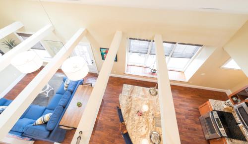 an overhead view of a living room with blue furniture and windows at The Newport Lofts - 546 Thames Street in Newport