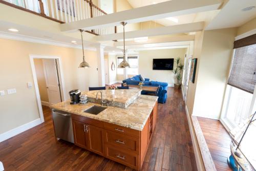 a kitchen and living room of a home with a sink at The Newport Lofts - 546 Thames Street in Newport