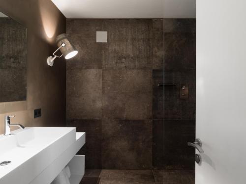 a bathroom with a sink and a shower at Guesthouse Suiteseven in Merano