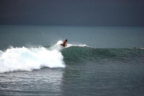 a man riding a wave on a surfboard in the ocean at La Ponderosa in Pavones