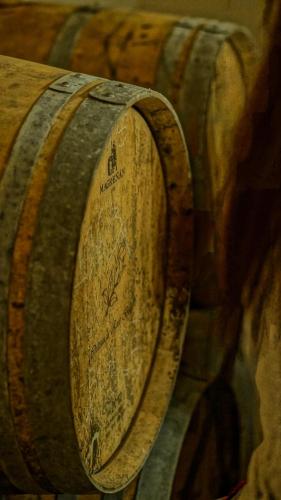 a wooden barrel with a label on it at Bordeaux Village Blaye in Blaye