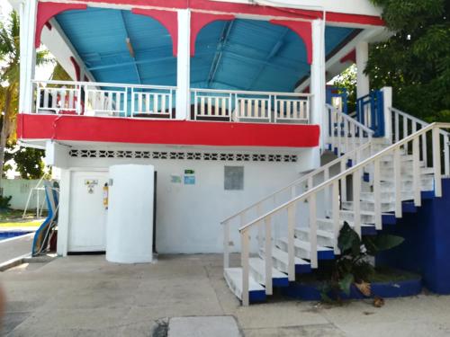 a building with blue and white stairs in front at Hotel Sael in Tocaima