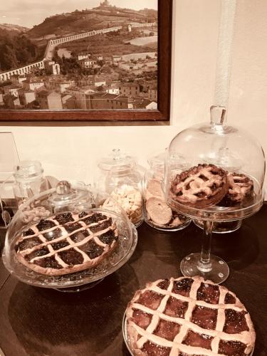 a table with three trays of cakes and pies at Podere Boschetto R&B in Bologna