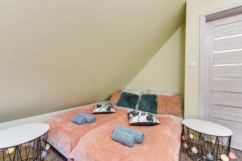 a bedroom with a bed with two pillows on it at Chëcz Kaszëbsko 59 in Załakowo