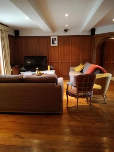 a living room with a couch and a chair at La Bergerie de Lives in Namur