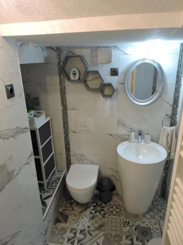 a bathroom with a white toilet and a sink at Apartments Perla in Biograd na Moru