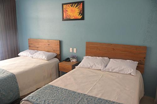 Postel nebo postele na pokoji v ubytování Acapulco Amor