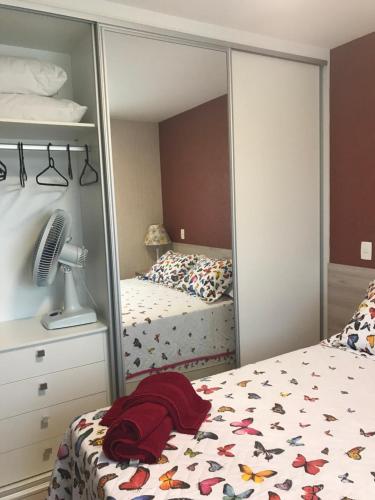 a bedroom with a mirror next to a bed at Anitta 2 in Sao Paulo