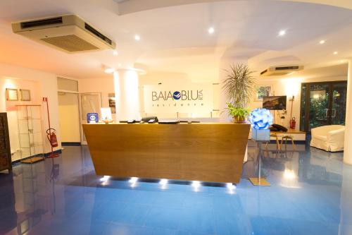 a lobby with a desk in the middle of a room at Baia Blu RTA Residence in Lerici