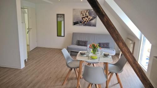 a dining room and living room with a table and chairs at Mosel Ausblick in Zell an der Mosel