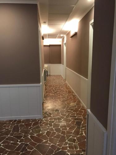 a hallway of an office with a stone floor at Hotel Paganini in Florence