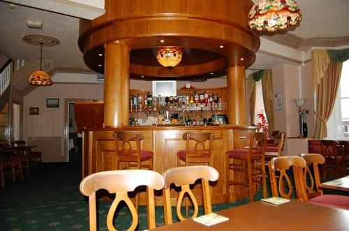 a dining room with a wooden table and chairs at The Waverley Hotel Maryport in Maryport