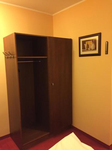 a black cabinet in the corner of a room at Virgo B&B Biznes Rumia in Rumia