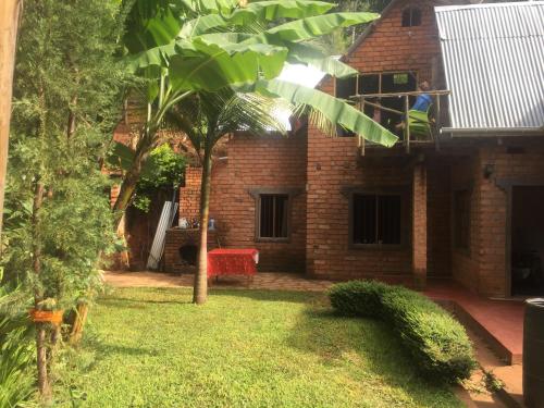 a person on the balcony of a brick house at David Crater Homestay in Lushoto