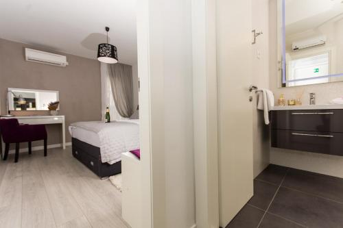 a hotel room with a bed and a bathroom at Adriatic Blue View in Split