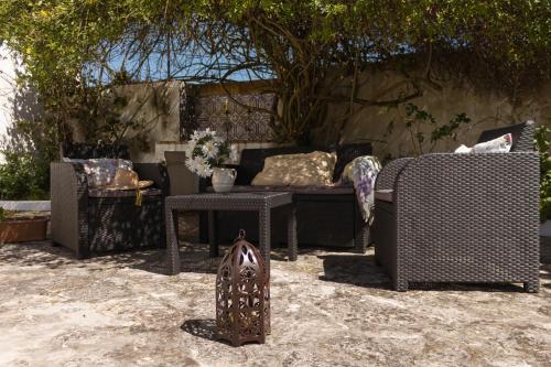 a patio with a couch and a table at Casa Rústica in Serra do Bouro