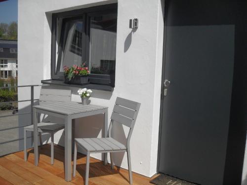 a table and chairs on a balcony with a door at Zimmer zum Hof in Herdecke