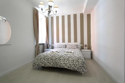 a bedroom with a bed and a striped wall at Adriatico Turin Centre in Turin