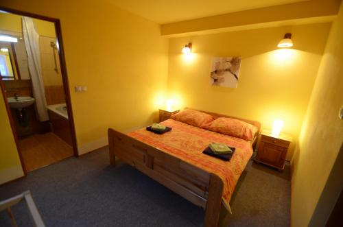 a bedroom with a bed and a bathroom with a mirror at Salas-Partizanske in Partizánske