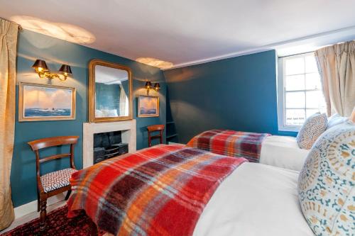 a bedroom with two beds and a fireplace at Luxury Regency Apartment in Bath City Centre in Bath