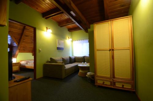 a living room with a couch and a bedroom at Salas-Partizanske in Partizánske