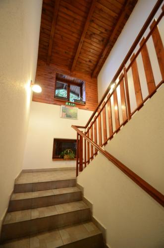 a staircase in a house with a wooden ceiling at Salas-Partizanske in Partizánske