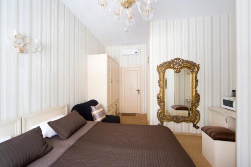 a bedroom with a large bed and a mirror at Avenue in Saint Petersburg