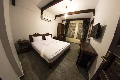 a hotel room with a bed and a television at Hotel Mary's House in Selcuk