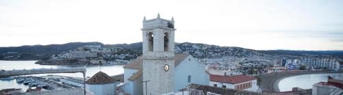 a tall building with a clock tower on top of it at La Sepia Boba (Adults only) in Peñíscola