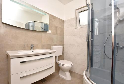 a bathroom with a toilet and a sink and a shower at Apartment Dora in Duće