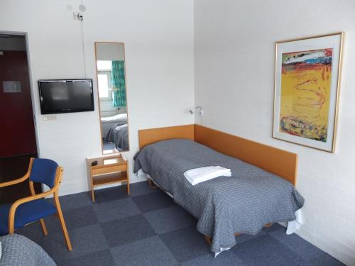 Säng eller sängar i ett rum på Motel Spar 10