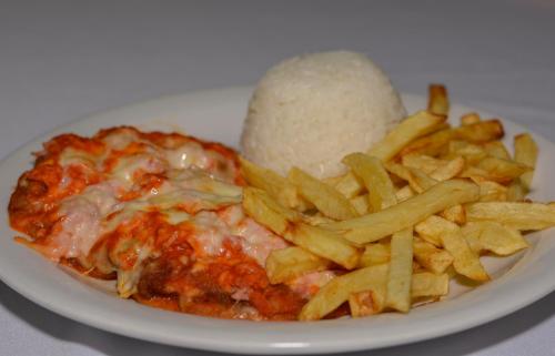 a plate of food with pasta and french fries at Hotel Real São Lourenço in São Lourenço