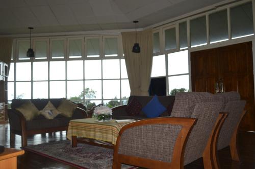 a living room with a couch and a table at Mesilau Mountain Retreats in Kundasang