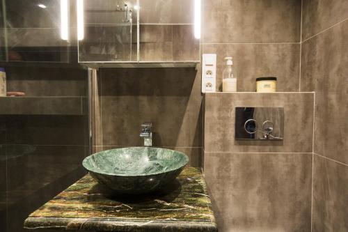 a bathroom with a large bowl sink on a counter at Chateau Clemenceau in Antibes