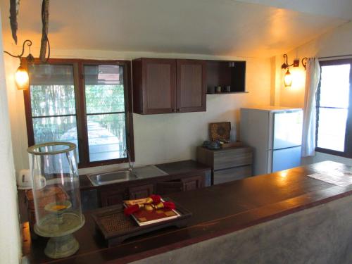 a kitchen with a counter top and a refrigerator at Jasmine Hills Lodge in Doi Saket