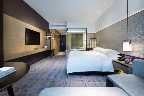 a hotel room with a large bed and a tv at Crowne Plaza Baoji City Center by IHG in Baoji