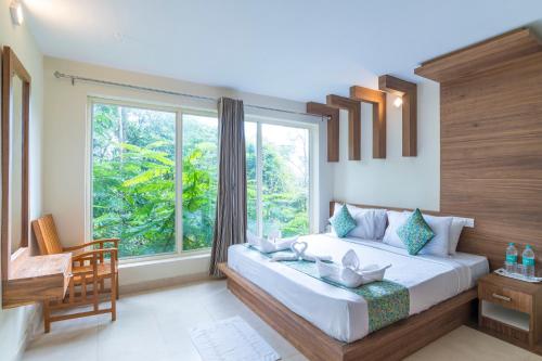 A bed or beds in a room at Letstay Adithya Nature Resort & Spa